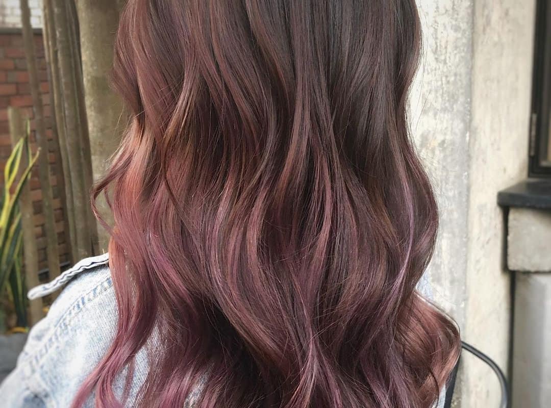 brown balayage with strawberry highlights